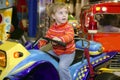 Blond little girl in funfair fairground attraction