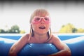 Blond little girl playing in the pool Royalty Free Stock Photo