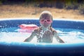 Blond little girl playing in the pool Royalty Free Stock Photo