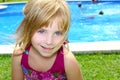 Blond little girl pool vacation smiling portrait