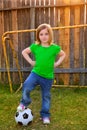 Blond little girl soccer player happy in backyard Royalty Free Stock Photo