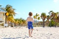 Blond little kid boy having fun on Miami beach, Key Biscayne. Happy healthy cute child playing with sand and running Royalty Free Stock Photo