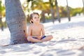 Blond little kid boy having fun on Miami beach, Key Biscayne. Happy healthy cute child playing with sand and running Royalty Free Stock Photo