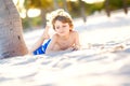 Blond little kid boy having fun on Miami beach, Key Biscayne. Happy healthy cute child playing with sand and running Royalty Free Stock Photo