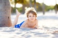 Blond little kid boy having fun on Miami beach, Key Biscayne. Happy healthy cute child playing with sand and running Royalty Free Stock Photo