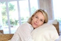 Blond mature woman lying on sofa Royalty Free Stock Photo