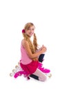 Blond pigtails roller skate girl on her knees happy Royalty Free Stock Photo