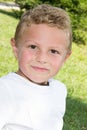 Blond portrait cute little boy in home green grass garden Royalty Free Stock Photo