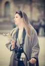 Blond positive girl holding brochure in hands