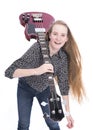 Blond teen girl and bass guitar against white background in studio Royalty Free Stock Photo