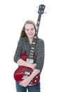 Blond teen girl and bass guitar against white background in studio Royalty Free Stock Photo