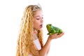 Blond princess girl kissing a frog green toad Royalty Free Stock Photo