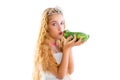 Blond princess girl kissing a frog green toad Royalty Free Stock Photo