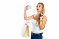 Blond shopaholic woman bags and smartphone