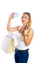 Blond shopaholic woman bags and smartphone