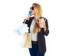 Blond shopaholic woman bags and smartphone