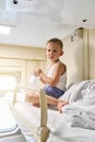 Little boy sitting on top shelf of train carriage Royalty Free Stock Photo