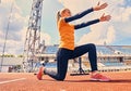 Blond sporty female runner to quick start position. Royalty Free Stock Photo