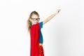 Happy and cool blond supergirl with glasses and red robe und blue shirt is posing in the studio Royalty Free Stock Photo