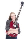 Blond teen girl and bass guitar against white background in studio Royalty Free Stock Photo