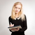 Blond Teen Girl Writing Notes On Notepad