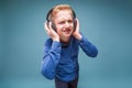 Teenager in headphones with a sour face listening to music Royalty Free Stock Photo