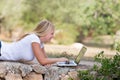 Blond teenager using laptop outdoor Royalty Free Stock Photo