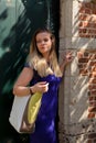 Blond woman antique door brick wall, Groot Begijnhof, Leuven, Belgium