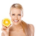 Blond woman with beautiful smile holding orange