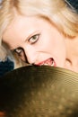 Blond Woman Biting Cymbal Royalty Free Stock Photo