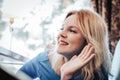 Blond woman in blue dress in cafe Royalty Free Stock Photo