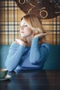 Blond woman in blue dress in cafe Royalty Free Stock Photo