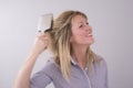 Blond woman brushing her hair Royalty Free Stock Photo