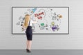 Blond woman drawing colorful project launch sketch Royalty Free Stock Photo