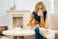Blond woman feeling bad and having runny nose