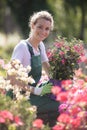 blond woman with hat gardening Royalty Free Stock Photo