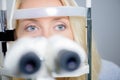 Blond woman having eye exam Royalty Free Stock Photo