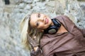 blond woman with headphones playing with her hair Royalty Free Stock Photo