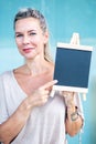 Blond woman holding a chalboard Royalty Free Stock Photo