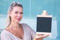 Blond woman holding a chalboard Royalty Free Stock Photo