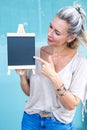 Blond woman holding a chalboard Royalty Free Stock Photo