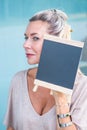 Blond woman holding a chalboard Royalty Free Stock Photo