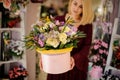 Blond woman holding hat box with flowers Royalty Free Stock Photo