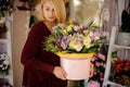 Blond woman holding hat box with flowers Royalty Free Stock Photo