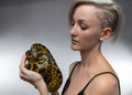 Blond woman holding yellow anaconda Royalty Free Stock Photo