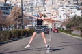 Blond woman with little pigtails jump in the middle of a high speed road