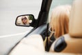 Blond fashion woman looking in the car mirror Royalty Free Stock Photo