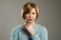 Blond woman looking suspicious and grumpy in discontent and tension face expression Royalty Free Stock Photo