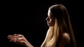 Blond woman praying to God, holding cross in hands, faith and spirituality Royalty Free Stock Photo