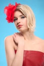 Blond woman with a red flower in hair Royalty Free Stock Photo